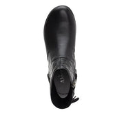 Top-down view of a black ankle boot against a white background. 