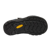 Black sandal sole with a yellow logo on a light gray background