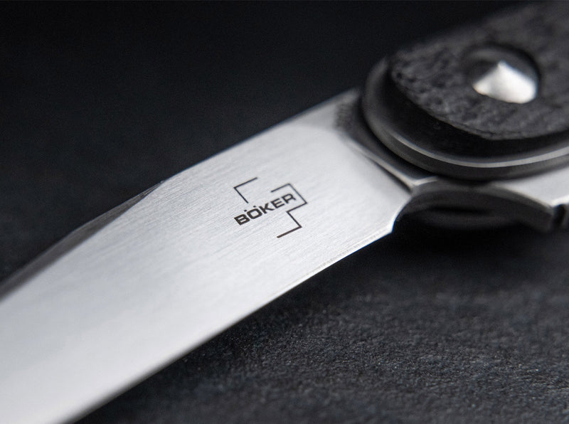 Close up image of the blade of a knife with a visible Boker logo on it.
