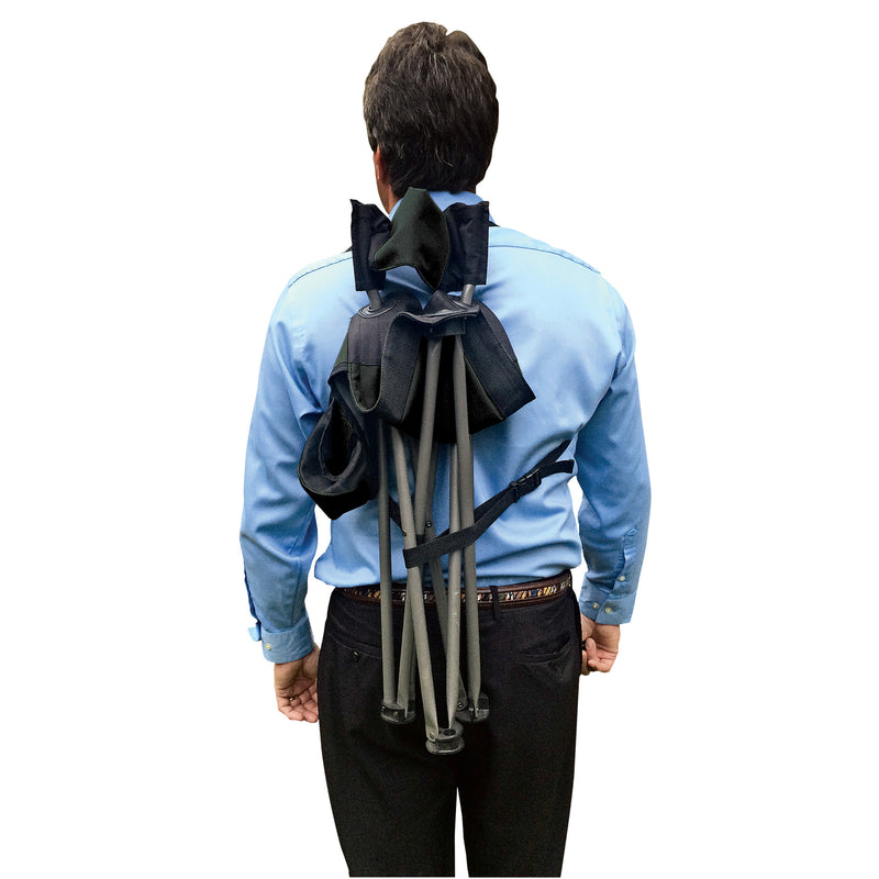 Person carrying a folding chair with a backstrap