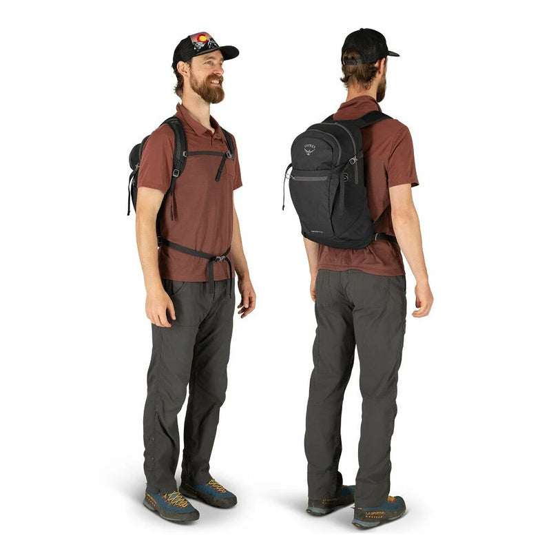Man wearing a black backpack on a white background.