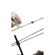 Fishing rod with a hand holding a tube of 'Shine' product on a white background