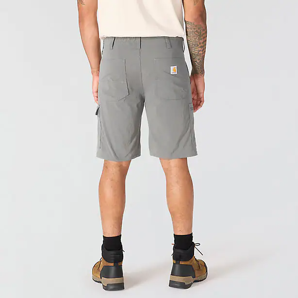 The back of a person wearing a pair of gray cargo shorts on a white background