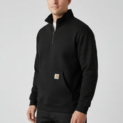 Man wearing a black 1/4 zip jacket with a Carhartt logo on the pocket on a white background.