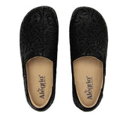 Black slip-on shoes with embossed design on a white background