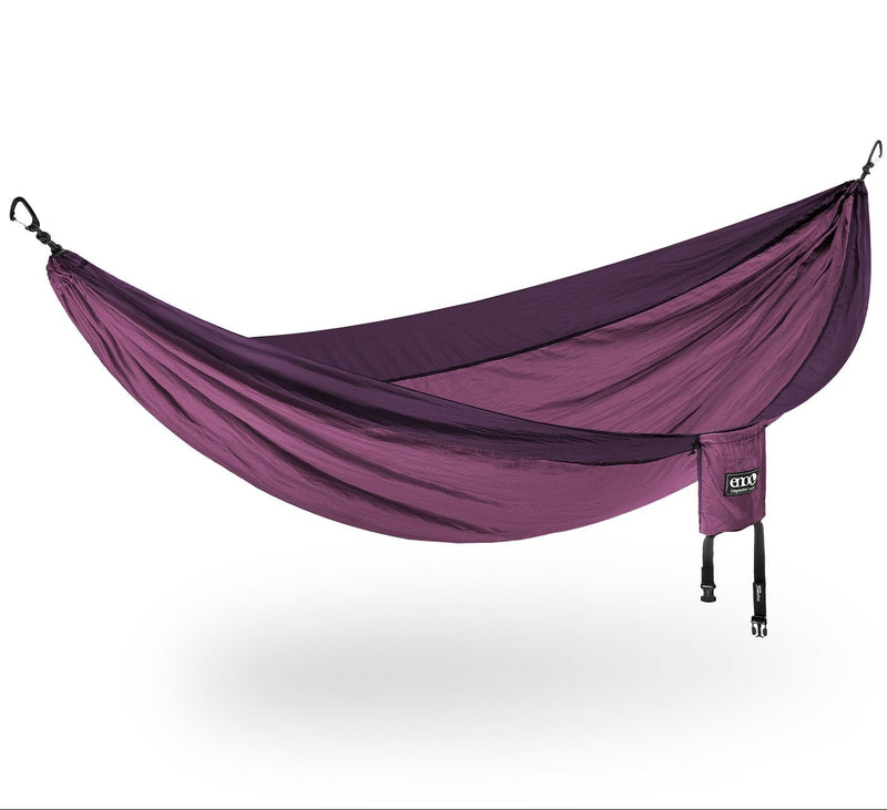 Purple camping hammock with carrying bag on a white background