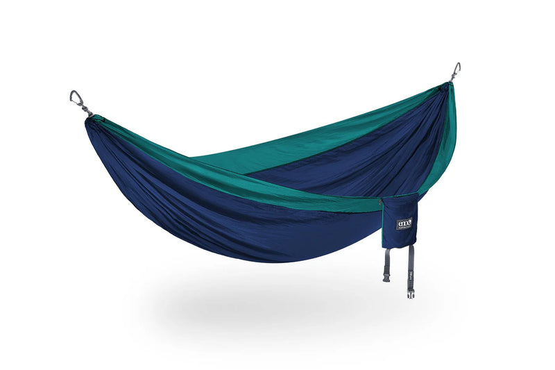 A dark blue hammock with teal lining on a white background