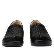 Pair of black loafers with intricate patterns on a white background