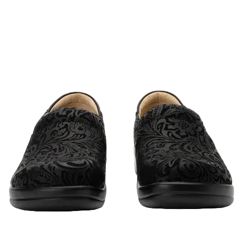 Pair of black loafers with intricate patterns on a white background