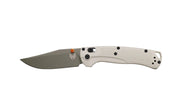 Folding knife with a beige handle and silver blade on a white background