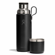 Black Hydro Flask water bottle and cup on a white background