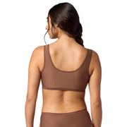 Woman wearing a brown bikini set with a plain background