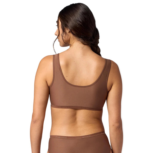 Woman wearing a brown bikini set with a plain background