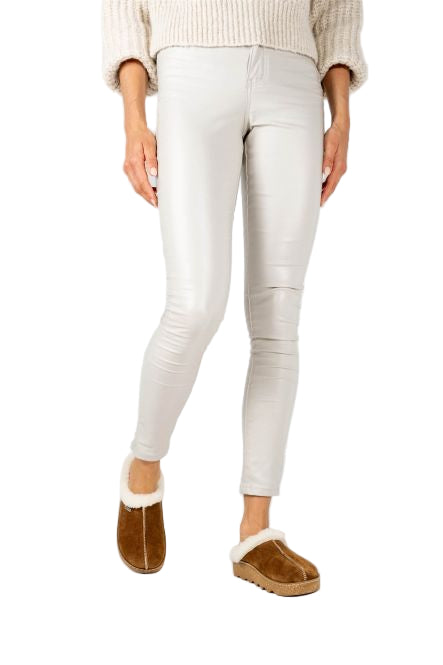 Person wearing light gray leggings and brown slippers on a white background