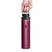 Pink Hydro Flask water bottle with a hand holding the lid on a white background