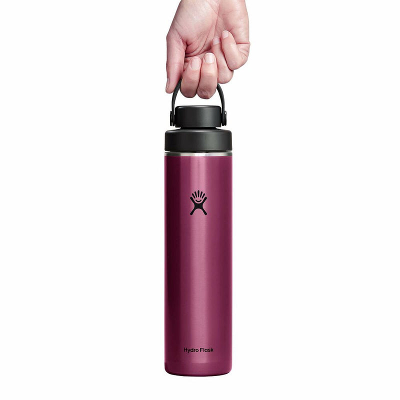 Pink Hydro Flask water bottle with a hand holding the lid on a white background