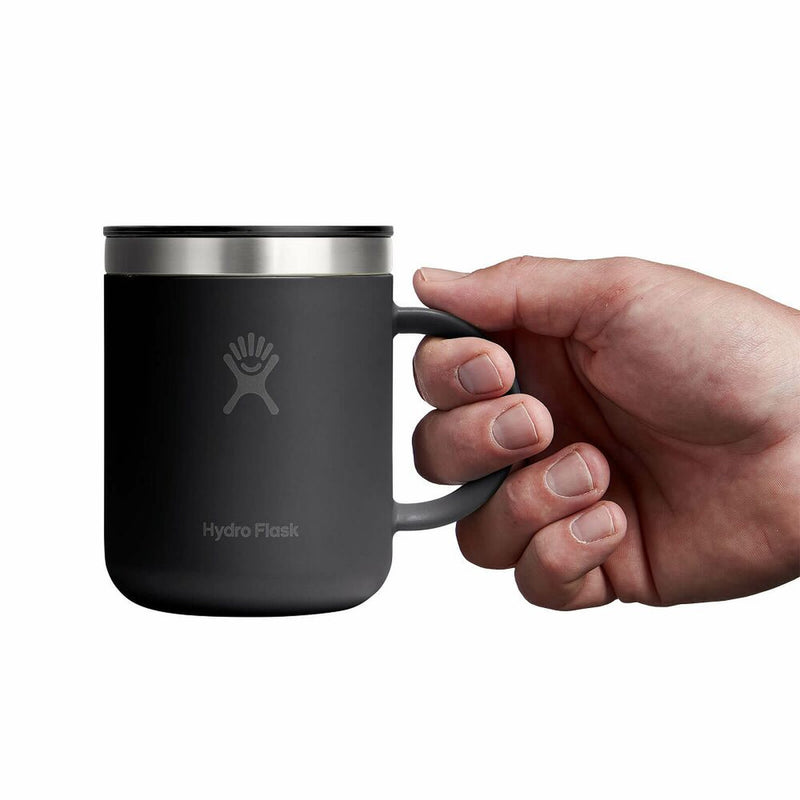 Black Hydro Flask mug held by a hand on a white background