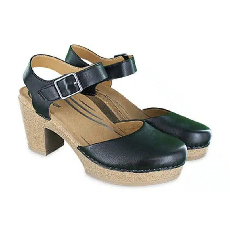 Side view of a pair of tan and black high heeled sandals that have silver buckles against a white background. 