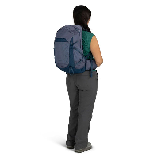 Person wearing a blue backpack on a white background