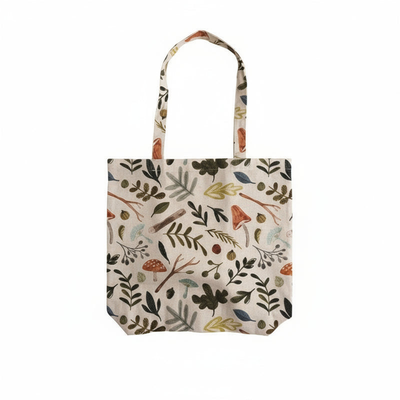 Tote bag with nature-themed pattern on a white background