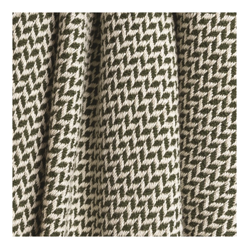 White and green throw blanket with a wavy design. 