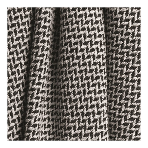 Close up of a black and white colored throw blanket with a wavy design.