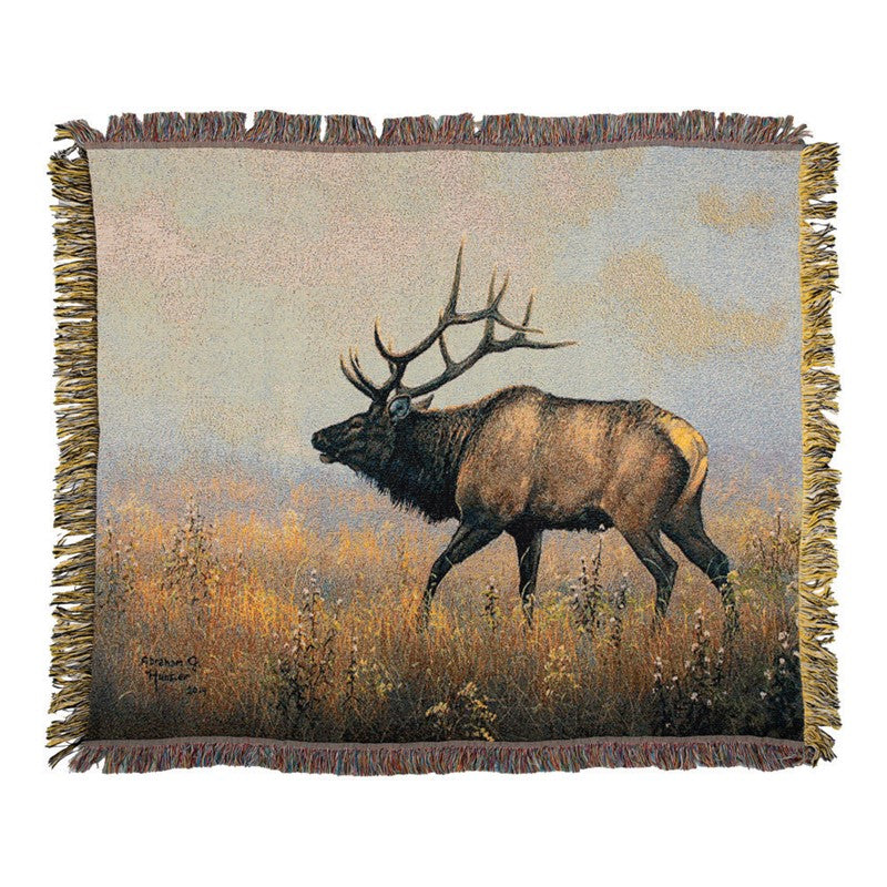 Throw blanket featuring a large moose walking through a field against a white background. 