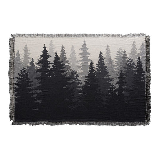 Throw blanket featuring several silhouettes of pine trees against a white background. 