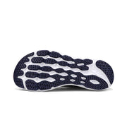 The bottom of a gray running shoe on a white background
