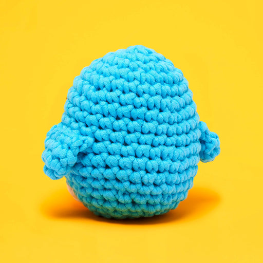 Blue knitted toy on a yellow background