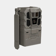 A rugged gray tactical trail camera with a side-mounted flip-out antenna, featuring a prominent front lens and the brand name 'REVEAL' embossed on the lower front, set against a plain light gray background.