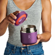 Person opening a vivid purple Hydro Flask food jar against a white background. 