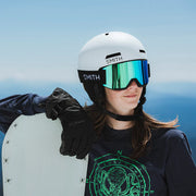 Person wearing a white helmet and goggles with a blue sky background
