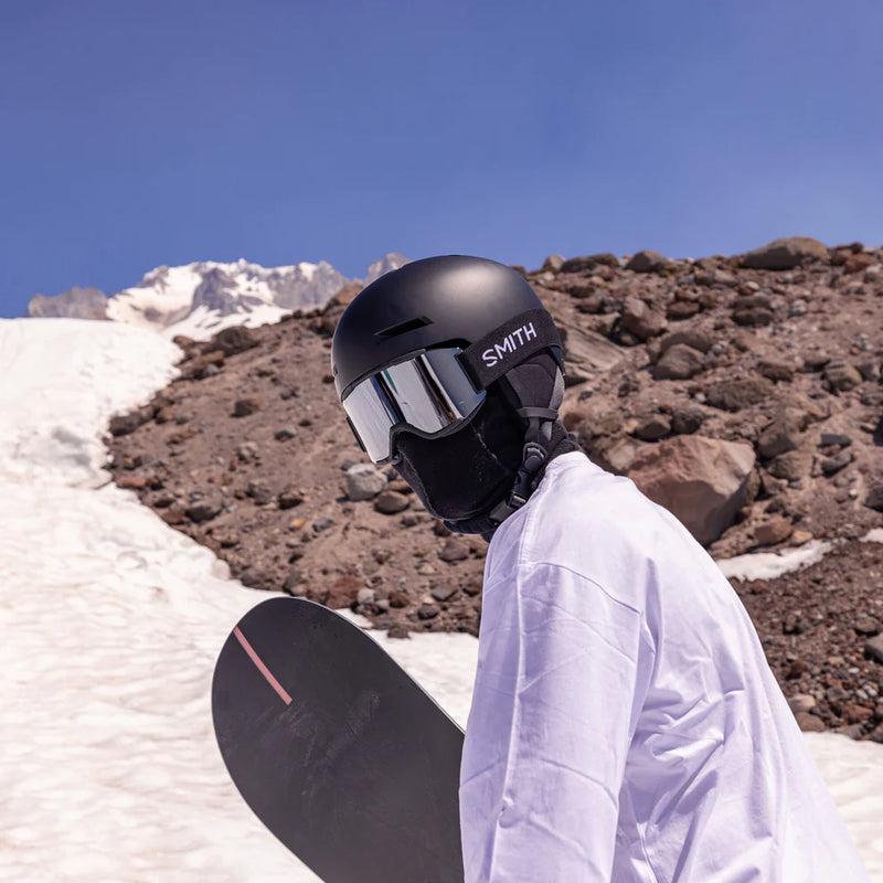 Person wearing a black Smith helmet with a mountainous background