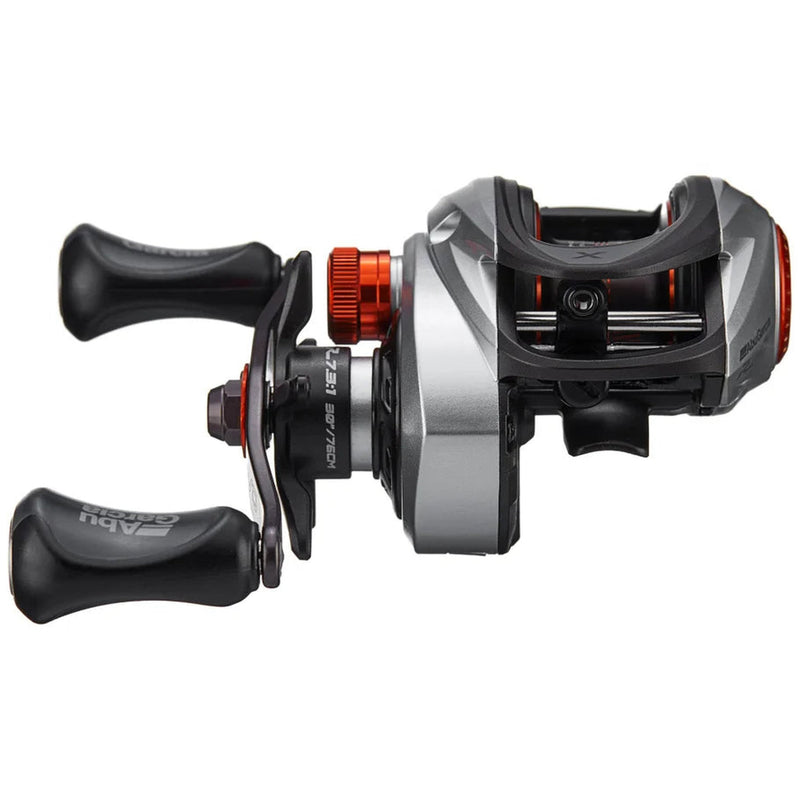 A black and gray fishing reel with red details on a white background