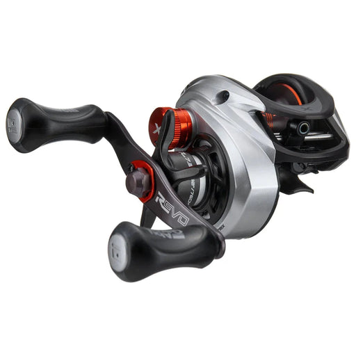 A black and gray fishing reel with red details on a white background