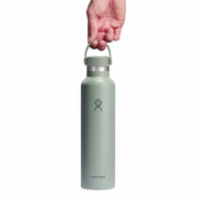Light green water bottle with a hand holding it on a white background