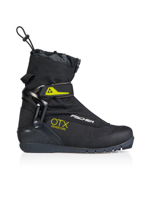 Side view of a black ski boot with yellow accents against a white background. 