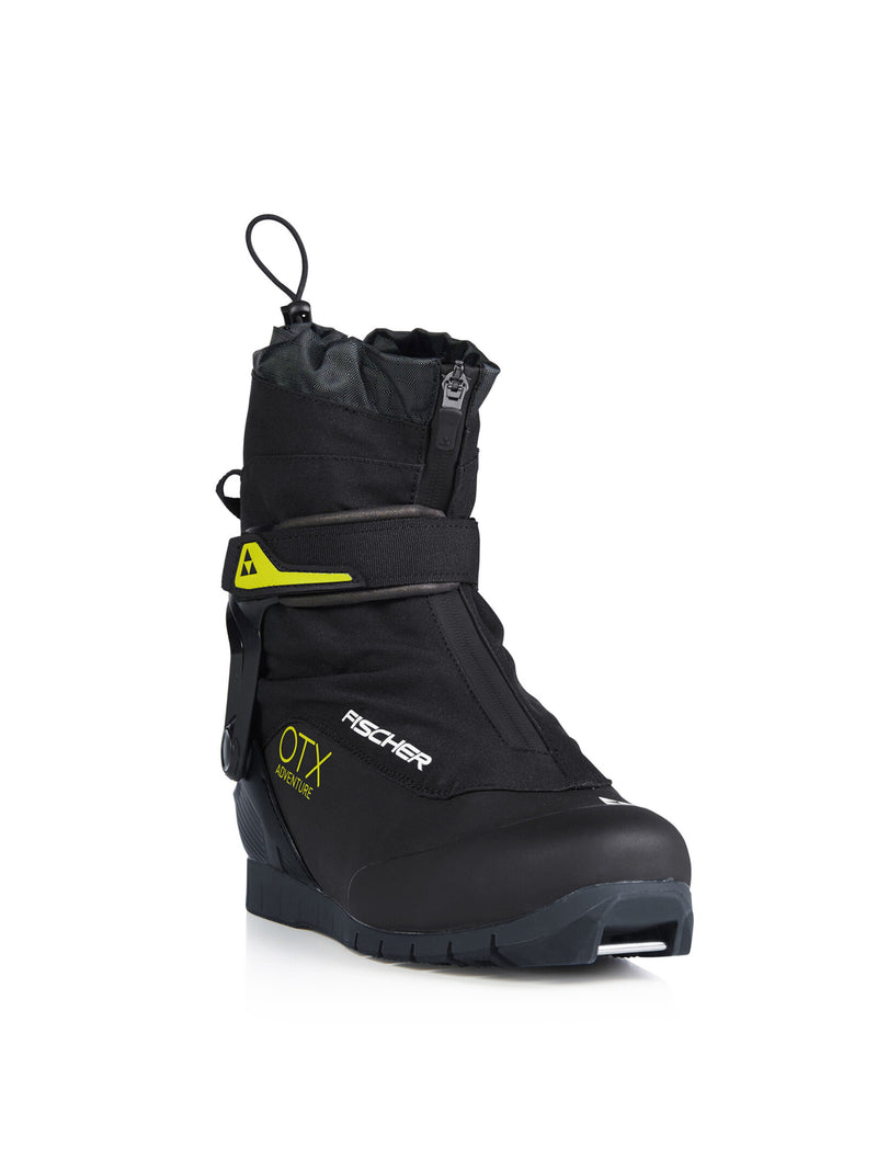 Side view of a black ski boot with yellow accents against a white background. 