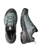 Pair of gray hiking shoes with brand logo on a white background