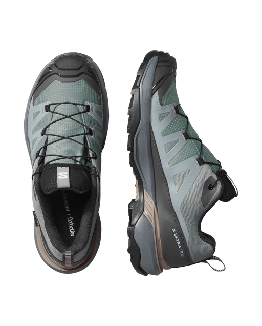 Pair of gray hiking shoes with brand logo on a white background