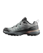 Gray hiking shoe with black sole on a white background