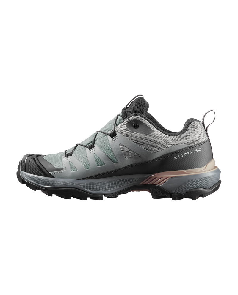 Gray hiking shoe with black sole on a white background