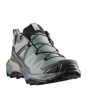 Gray hiking boot with black sole on a white background