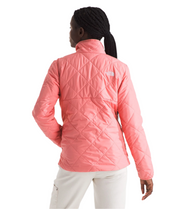 Person wearing a pink quilted jacket on a white background