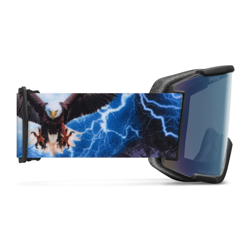 Goggles with a design of an eagle and lightning on the strap, on a white background.