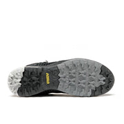 Bottom view showcasing the black and grey tread of a winter boot against a white background.
