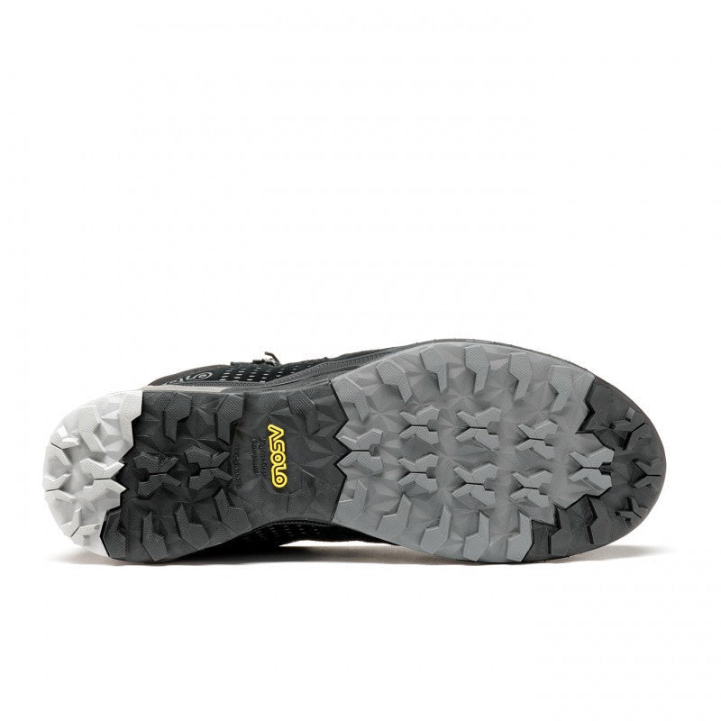 Bottom view showcasing the black and grey tread of a winter boot against a white background.
