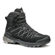 Side view of a black winter boot with grey accents against a white background. 
