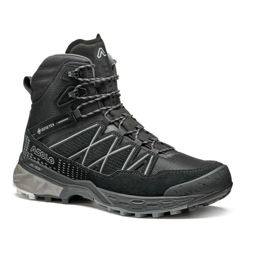 Side view of a black winter boot with grey accents against a white background. 
